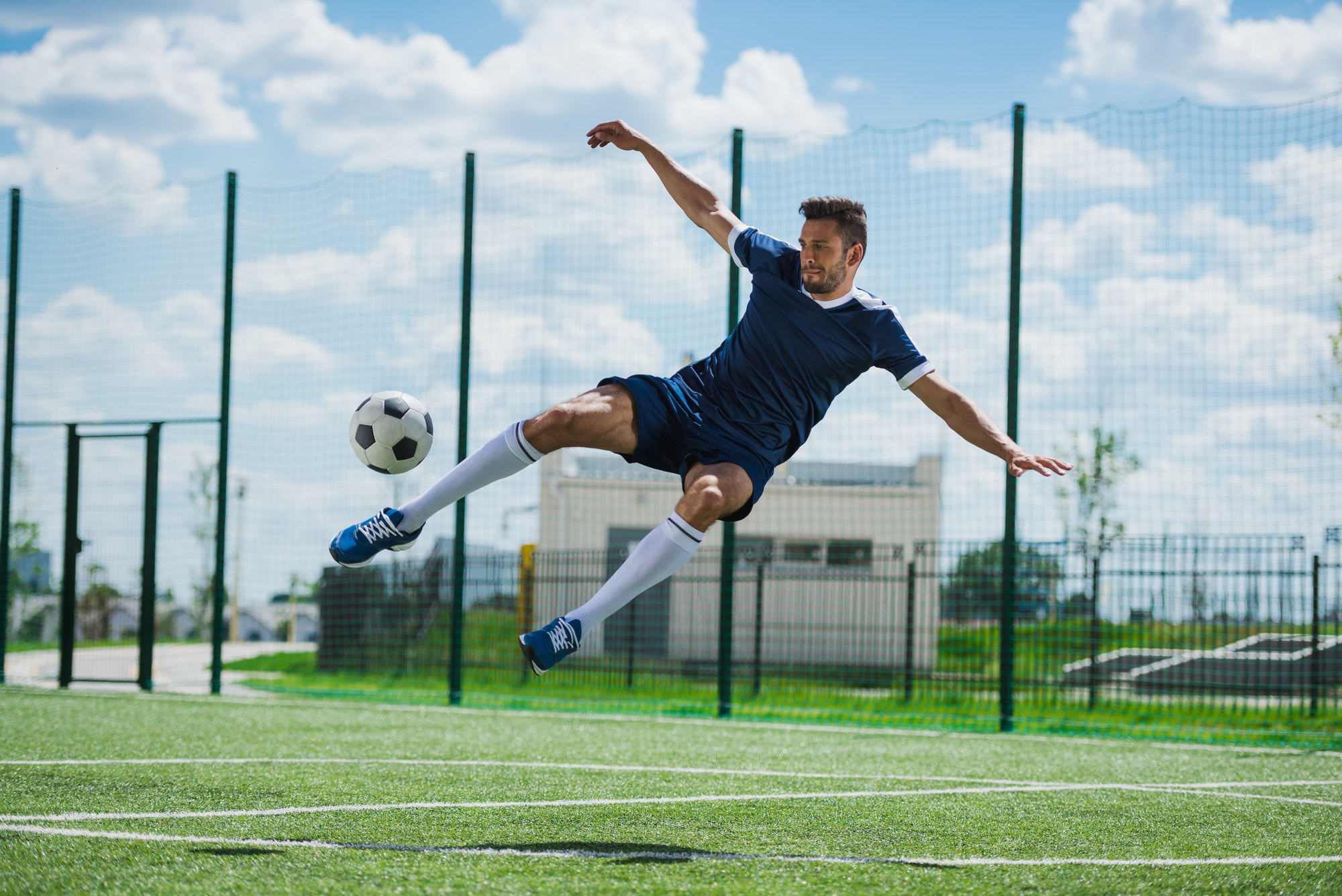 athletic-soccer-player-kicking-ball-on-soccer-pitch.jpg athletic-soccer-player-kicking-ball-on-soccer-pitch.jpg